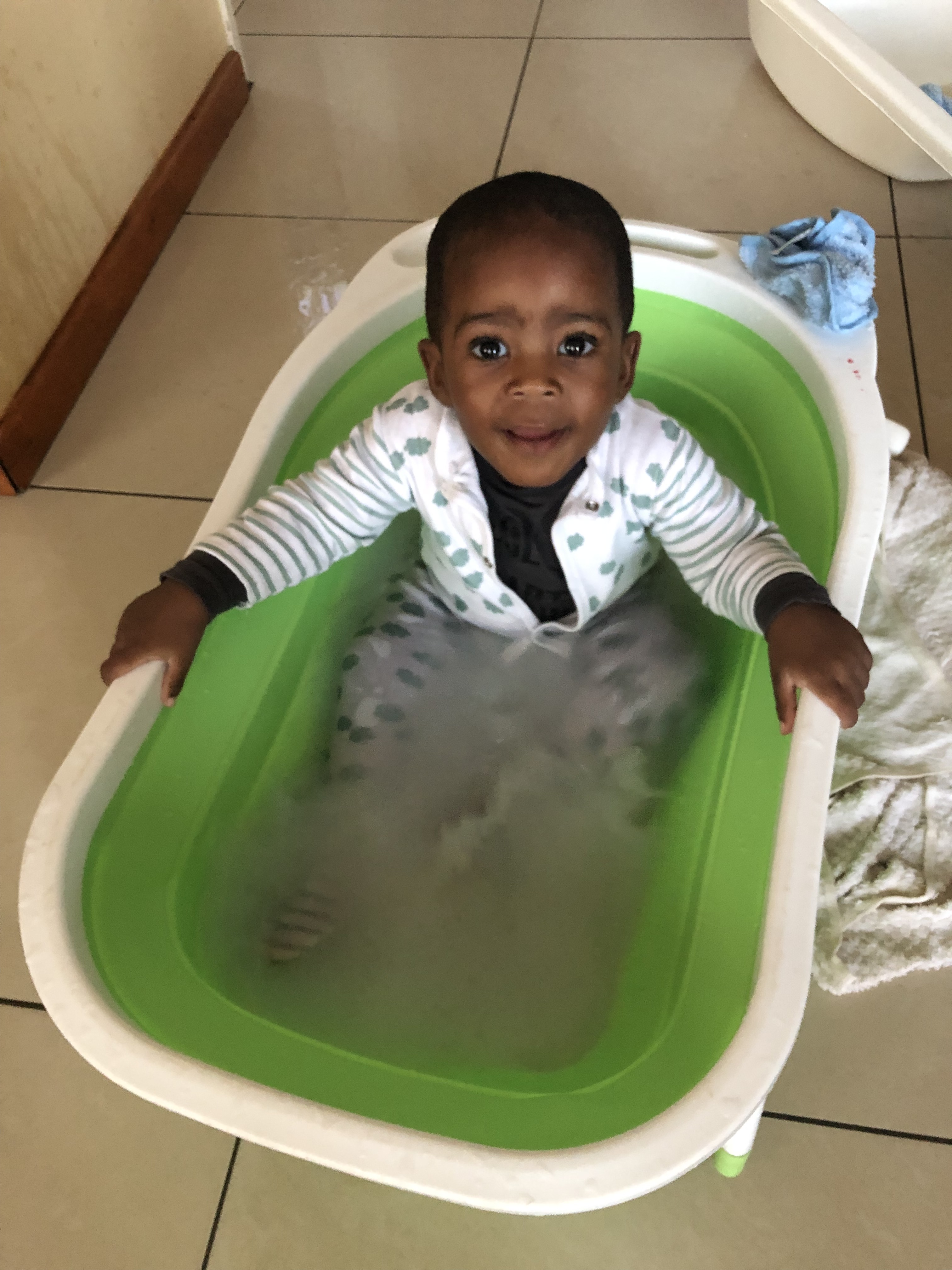 Toddler in a bath in pyjamas